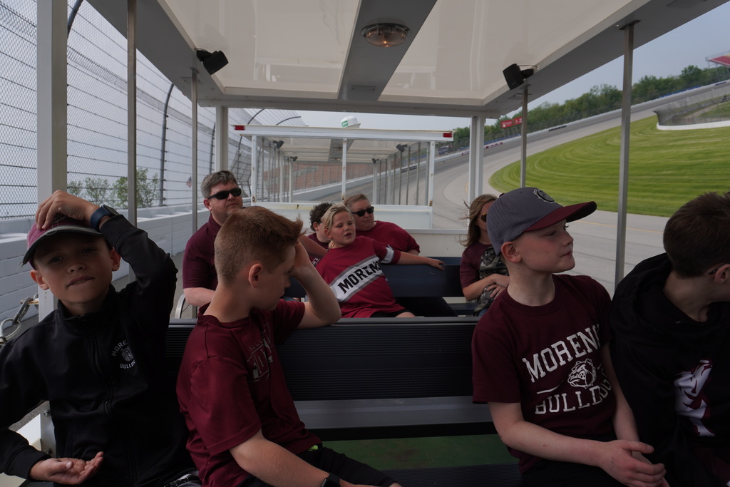 Students on a tram driving around Michigan International Speedway
